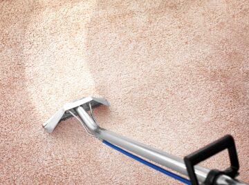 Anglesey Carpet Care Swishing wand over a carpet leaving a clean area